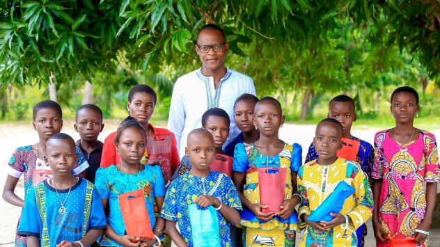 A photo of Philemon Padonou with CodeToHope children