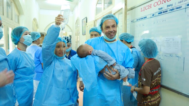 Kris Sterkens carries 6 month old Phuc