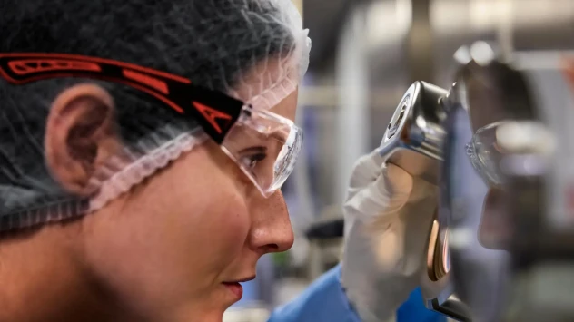 Close up of woman working on machine .webp