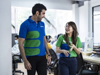 SwipeRX employees walking and talking around their office in Indonesia