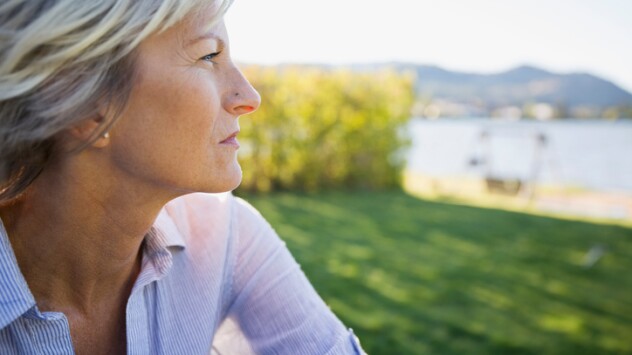 Close-up of a blonde woman looking at a lake