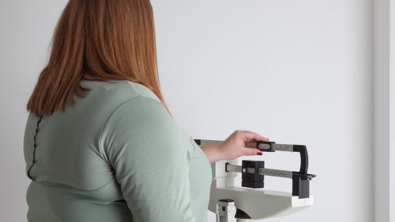 A photo of a women at a mechanical scale