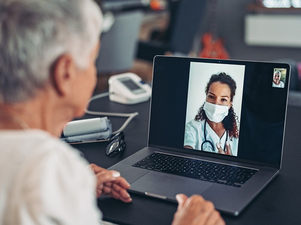 A woman doing a telehealth visit on her laptop