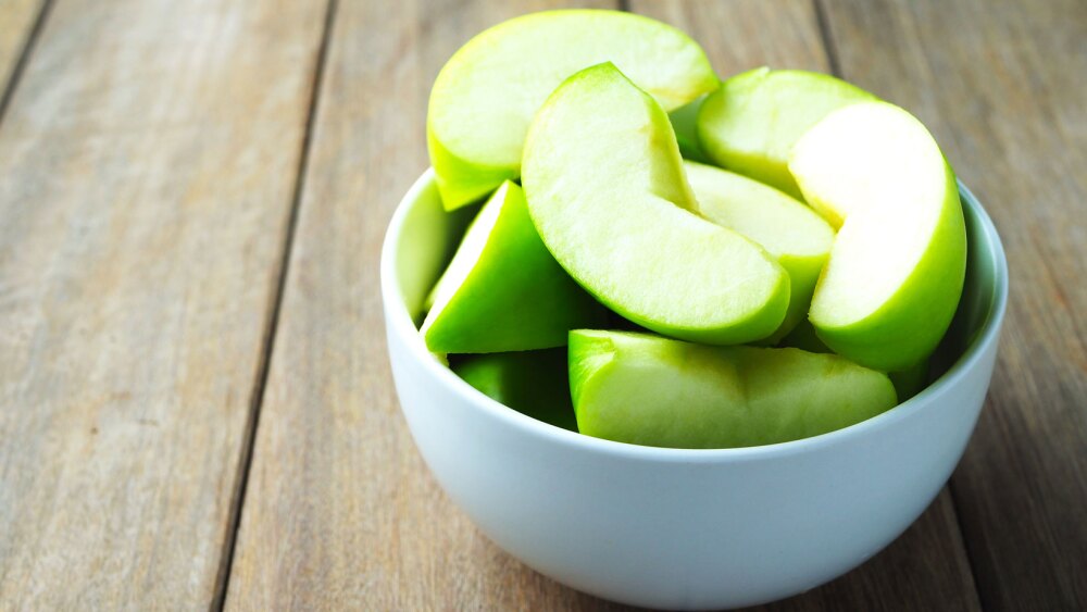 sliced green apple slices in a bowl