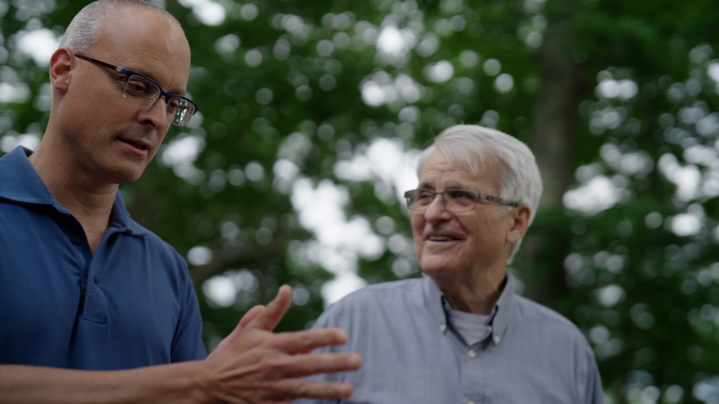 Two men in conversation while walking