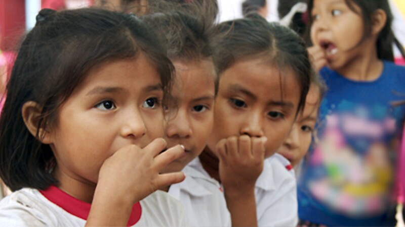 Young students taking chewable mebendazole to help treat intestinal parasites