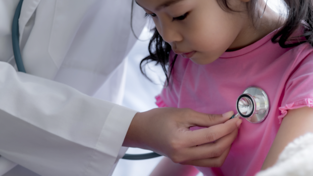 Doctor listening to a little girl's heartbeat with a stethoscope
