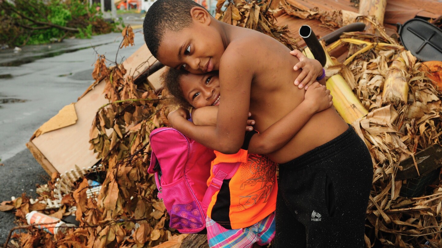 Two children hugging after Hurricane Maria