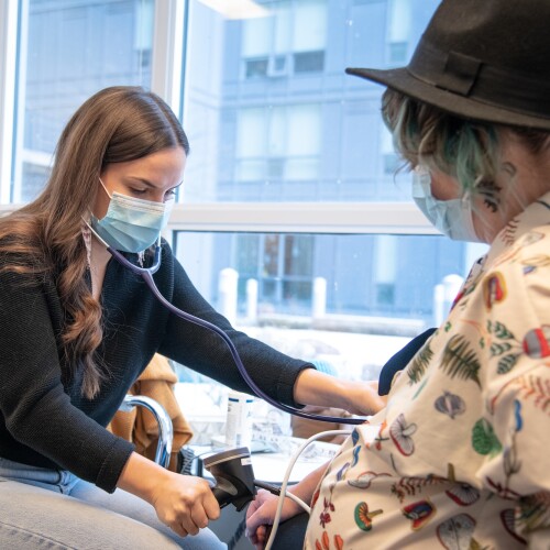 A nurse takes a patient's blood pressure