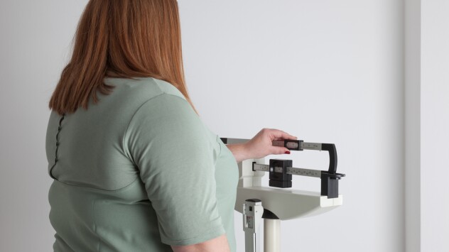 A photo of a women at a mechanical scale