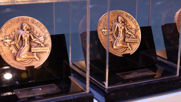 Image of three bronze Johnson Medals in glass cases