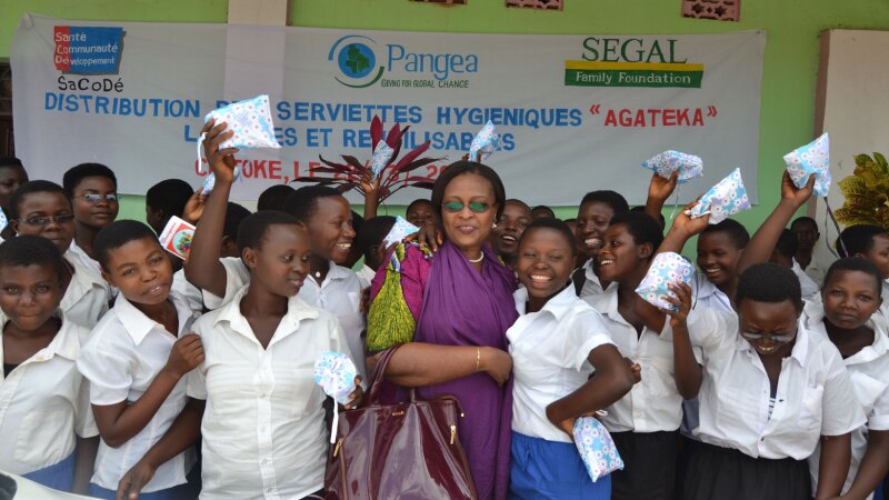 A photo of Francoise Nibizi distributing Agateka pads to students