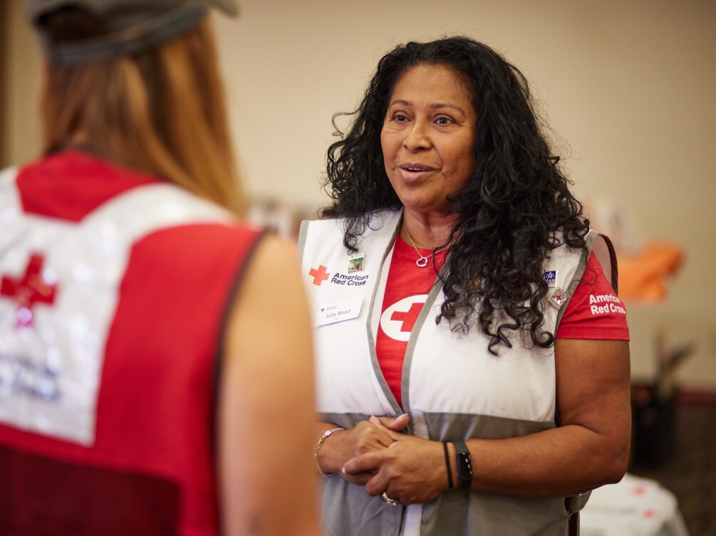 American Red Cross volunteer speaks with a colleague during a relief effort.
