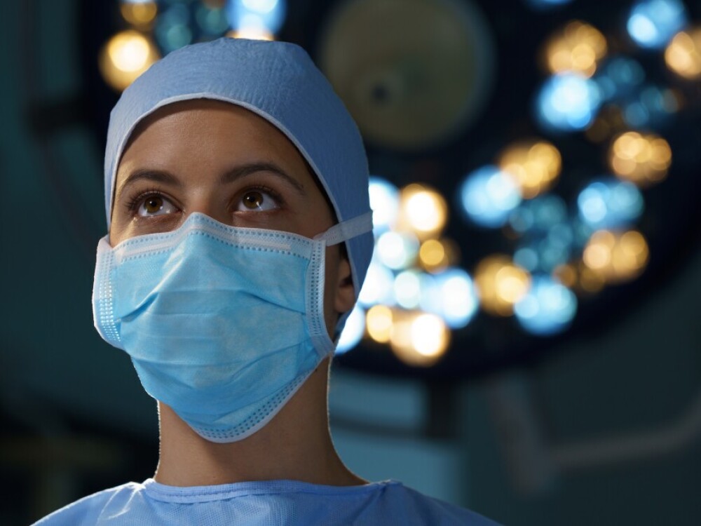 A healthcare professional in full PPE standing in the OR 