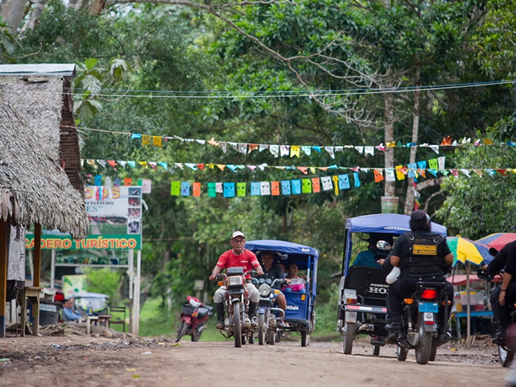 Professor Abner Isac Silva Acosta riding a motorcycle through Pucallpa