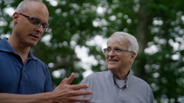 Two men in conversation while walking